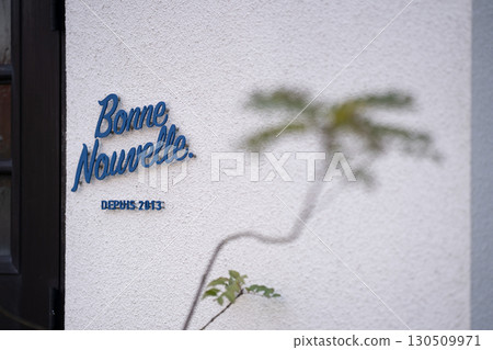A stylish cafe sign that stands out on a street corner in Kamakura 130509971