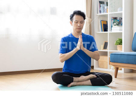 Middle-aged man doing yoga at home Middle-aged man doing yoga at home 130511080