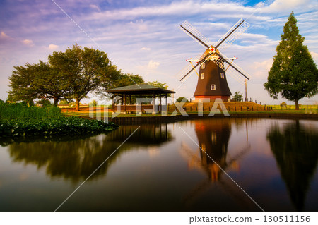 A sweet moment when the windmill is beautifully reflected in the pond in the evening sunshine A sweet moment when the windmill is beautifully reflected in the pond in the evening sunshine 130511156