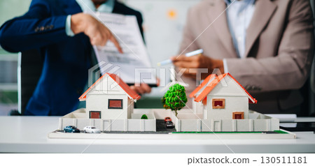 Real estate broker agent presenting and consult to customer to decision making sign insurance form agreement, home model 130511181