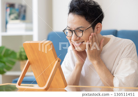 Beauty image: Middle-aged man looking in the mirror 130511451