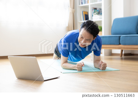 Middle-aged man training at home Middle-aged man training at home 130511663