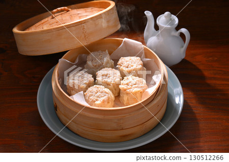 Note: Steam is synthetic. Shumai, Chinese food, steamed in a bamboo steamer. Note: Steam is synthetic. Shumai, Chinese food, steamed in a bamboo steamer. 130512266