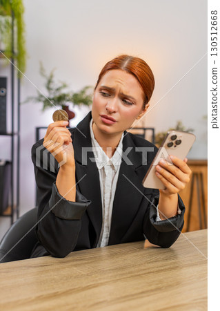 Young businesswoman sees crypto crash on smartphone sighs over investment loss and very disappointed Young businesswoman sees crypto crash on smartphone sighs over investment loss and very disappointed 130512668