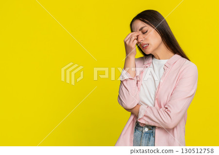 Woman tired rubbing eyes exhausted overworked needing rest showing fatigue sleepy facial expression Woman tired rubbing eyes exhausted overworked needing rest showing fatigue sleepy facial expression 130512758