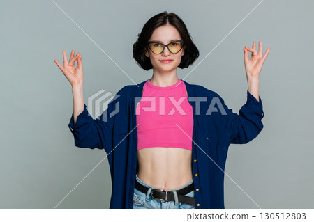 Woman meditating calmly with eyes closed breathing deeply expressing peace relaxation mindfulness Woman meditating calmly with eyes closed breathing deeply expressing peace relaxation mindfulness 130512803