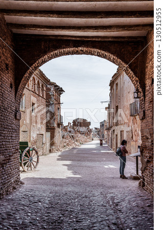 Tourist visiting ruined street in belchite viejo after spanish civil war 130512955