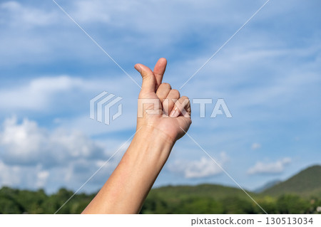 Korean Love Finger Heart Sign with Cloudy Sky Background Korean Love Finger Heart Sign with Cloudy Sky Background 130513034