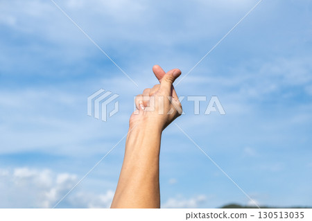 Finger Heart Hand Gesture Symbolizing Love and Positivity Outdoors 130513035