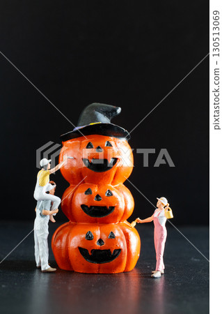 Creative Halloween Concept with Miniature Workers and Pumpkins Creative Halloween Concept with Miniature Workers and Pumpkins 130513069