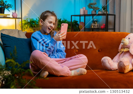 Young child kid girl texting share messages content on smartphone social media applications online 130513432