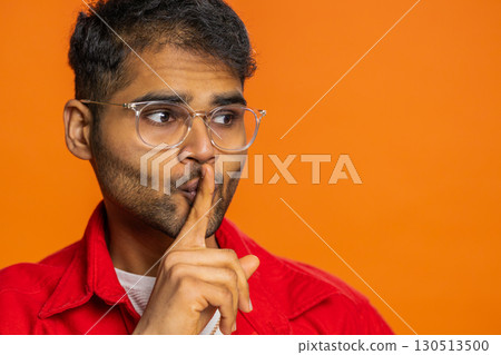 Indian man presses finger to lips make silence gesture sign do not tells secret stop gossip privacy Indian man presses finger to lips make silence gesture sign do not tells secret stop gossip privacy 130513500