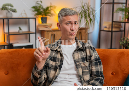 Displeased upset man reacting to unpleasant awful idea, dismiss bad idea, wave hand, shake head No 130513518