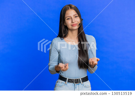 Young woman freelance worker in headset call center support service operator helpline having talk 130513519