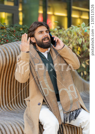 Happy surprised man involved in pleasant conversation phone call good news enjoying talking gossip 130513526