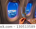 drinking champagne during a night flight 130513589