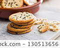 Crispy round salted crackers on white table. 130513656