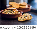 Crispy round salted crackers on black table. 130513660
