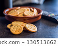 Crispy round salted crackers on black table. 130513662
