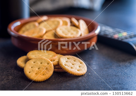 Crispy round salted crackers on black table. Crispy round salted crackers on black table. 130513662