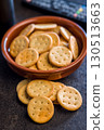 Crispy round salted crackers on black table. 130513663