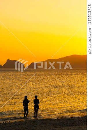 Bikini girls playing in the sunset sea, Okinawa scenery 130513798