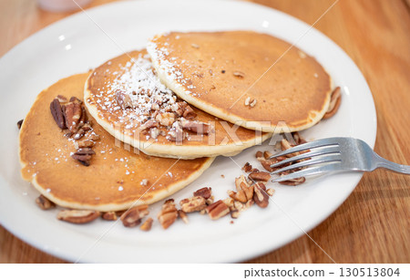 Pancakes with lots of nuts and a fork Pancakes with lots of nuts and a fork 130513804