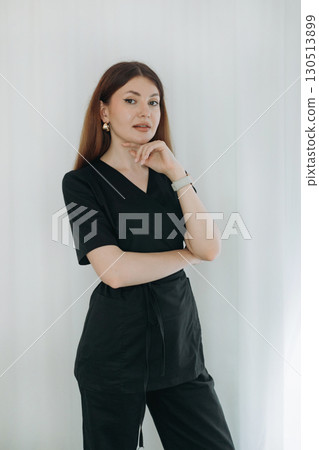 skilled aesthetician woman professional wearing black medical suit  130513899