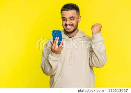 Happy excited winner man use smartphone celebrating success, winning play game, good lottery news Happy excited winner man use smartphone celebrating success, winning play game, good lottery news 130513967