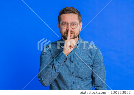 Man presses finger to lips make silence gesture sign do not tells secret stop gossip privacy Man presses finger to lips make silence gesture sign do not tells secret stop gossip privacy 130513992