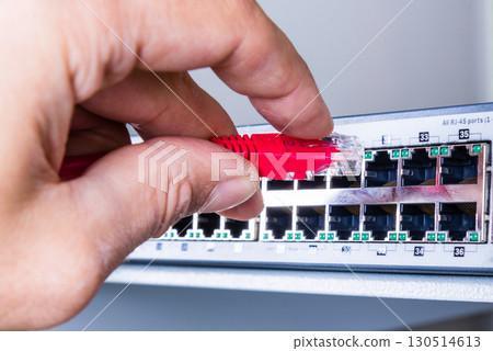hand with red ethernet cable 130514613