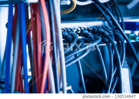 Detail of server room with bunch of fiber optic cables and ether 130514647