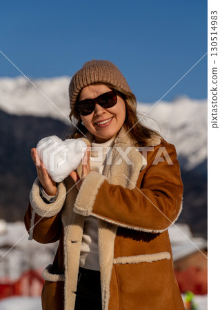 Snow Heart Woman Mountains Winter: Happy woman holding snow heart, sunny winter mountains, romantic snowy scene. 130514983