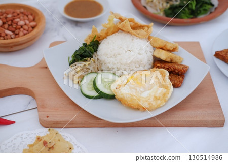 Fried Tempeh, Tofu, Egg, and Meat on Plate 130514986