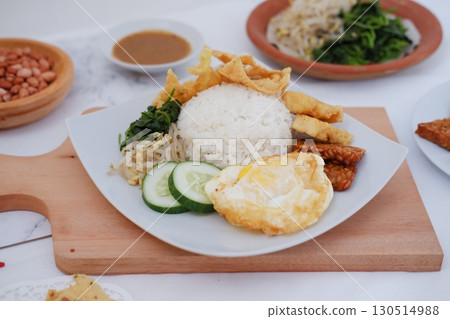 Fried Tempeh, Tofu, Egg, and Meat on Plate 130514988