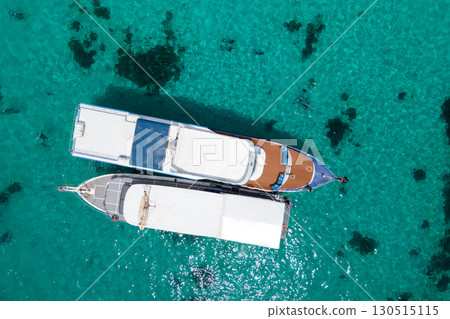 Aerial view of two recreational vessels over turquoise clear water at Racha Island, Phuket, Thailand Aerial view of two recreational vessels over turquoise clear water at Racha Island, Phuket, Thailand 130515115