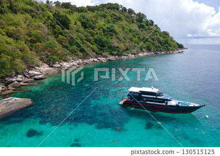 Aerial view of recreational vessel over turquoise clear water at Racha Island in Phuket, Thailand Aerial view of recreational vessel over turquoise clear water at Racha Island in Phuket, Thailand 130515125