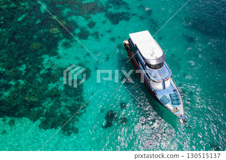 Aerial view of boat anchoring over turquoise clear water at Racha Island in Phuket, Thailand 130515137