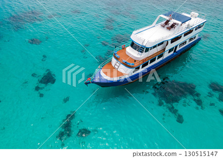 Aerial view of recreational vessel or scuba diving boat anchoring over turquoise clear water Aerial view of recreational vessel or scuba diving boat anchoring over turquoise clear water 130515147
