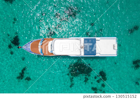 Aerial view of recreational boat anchoring over turquoise water at Racha Island in Phuket, Thailand Aerial view of recreational boat anchoring over turquoise water at Racha Island in Phuket, Thailand 130515152