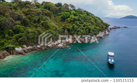 Aerial view of recreational boat anchoring over turquoise water at Racha Island in Phuket, Thailand Aerial view of recreational boat anchoring over turquoise water at Racha Island in Phuket, Thailand 130515153