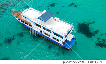 Aerial view of diving boat over turquoise clear water at Racha Island in Phuket, Thailand. Aerial view of diving boat over turquoise clear water at Racha Island in Phuket, Thailand. 130515190