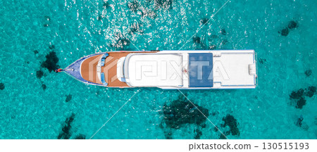 Aerial view of recreational boat over turquoise clear water at Racha Island in Phuket, Thailand. Aerial view of recreational boat over turquoise clear water at Racha Island in Phuket, Thailand. 130515193