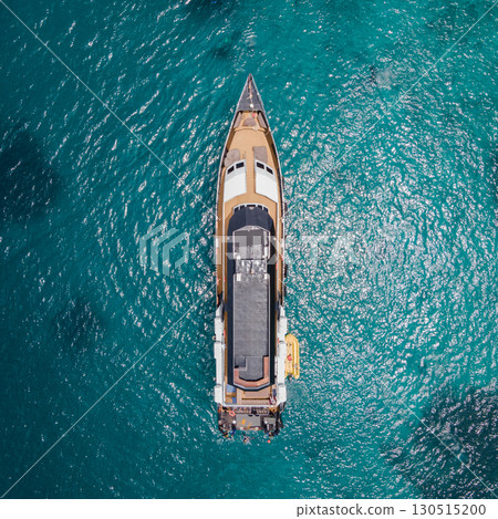 Aerial view of recreational vessel anchoring over turquoise clear water Aerial view of recreational vessel anchoring over turquoise clear water 130515200