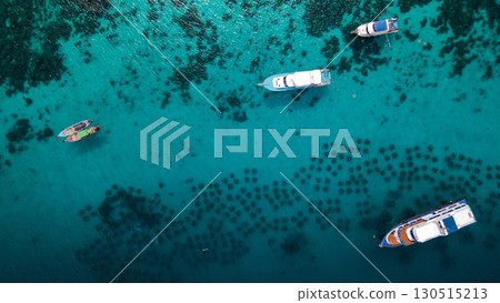 Aerial view of tour boats anchoring over the artificial reef at Racha Yai Island, Phuket, Thailand. Aerial view of tour boats anchoring over the artificial reef at Racha Yai Island, Phuket, Thailand. 130515213