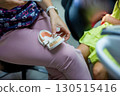 A healthcare professional uses a dental model to explain oral hygiene to a child, fostering understanding of dental care techniques in a friendly clinical setting. 130515416