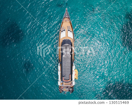 Aerial view of scuba diving boat over turquoise clear water 130515469
