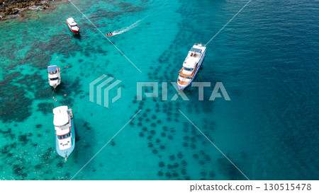Aerial view of Racha Yai Island with tour boats in the bay 130515478
