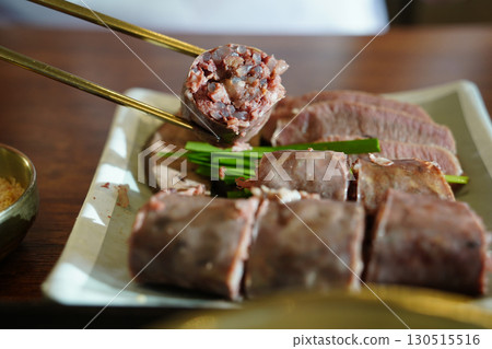 Korean Sausage (Sundae) Slices with Green Onions on Plate Korean Sausage (Sundae) Slices with Green Onions on Plate 130515516