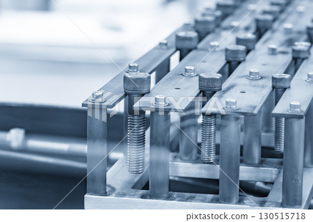 The vibration feeder the group of hexagon socket head screw caps in the light blue scene. The vibration feeder the group of hexagon socket head screw caps in the light blue scene. 130515718